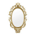 Miroir ovale orné avec cadre doré